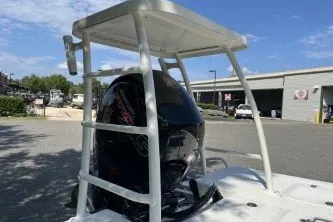 Slide: The Image of 2026 Mako 18 Pro Skiff with outboard motor and T-top in a marina setting. - 6