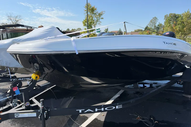 Slide: The Image of 2027 Tahoe T18 boat on trailer in outdoor setting, showcasing sleek design. - 1