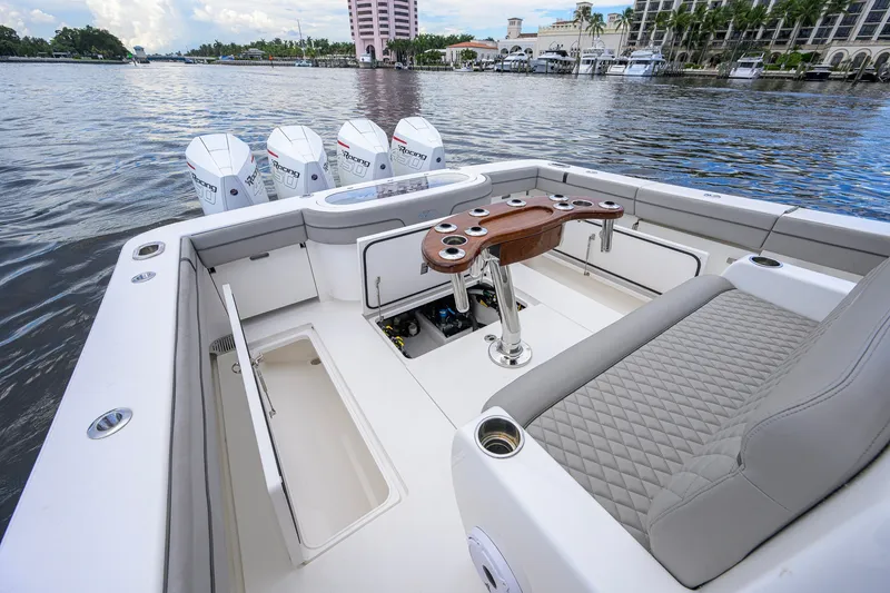 Slide: The Image of 2021 Valhalla V-41 boat interior with seating and fishing rod holders on a calm waterway. - 30