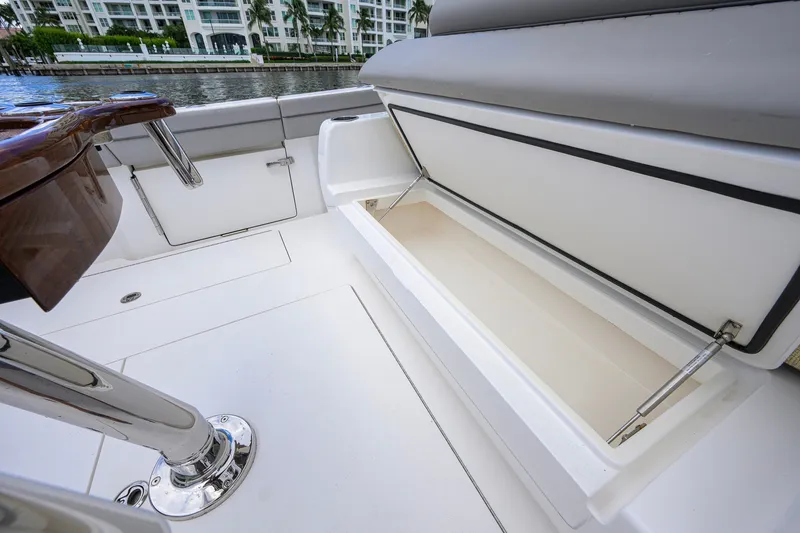 Slide: The Image of 2021 Valhalla V-41 boat interior with open storage compartment, sleek design, and waterfront view. - 33