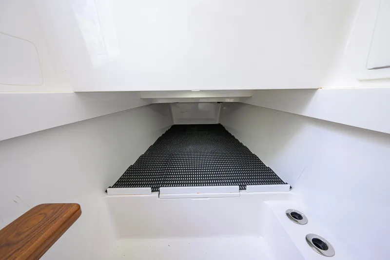 Slide: The Image of Interior view of 2021 Valhalla V-41 boat, featuring sleek white design and functional storage space. - 63
