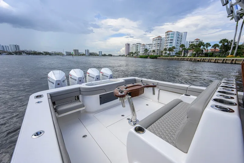 Slide: The Image of 2021 Valhalla V-41 boat with quad engines, cruising near waterfront buildings under cloudy skies. - 28