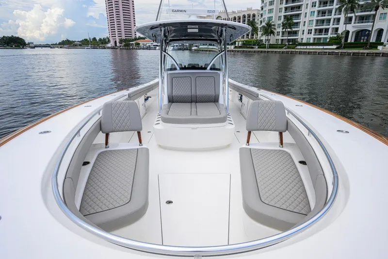 Slide: The Image of Valhalla V-41 boat interior with luxurious seating, docked near waterfront buildings. - 55