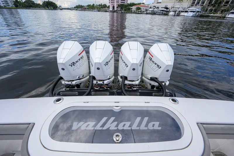 Slide: The Image of 2021 Valhalla V-41 boat with four powerful outboard engines on a serene waterway. - 19
