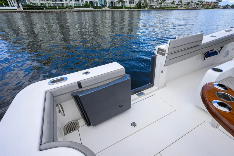 Slide: The Image of 2021 Valhalla V-41 boat deck with seating, overlooking calm waterfront and luxury buildings. - 35
