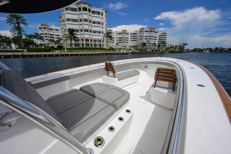 Slide: The Image of Luxurious 2021 Valhalla V-41 boat with elegant seating, cruising near waterfront buildings. - 49