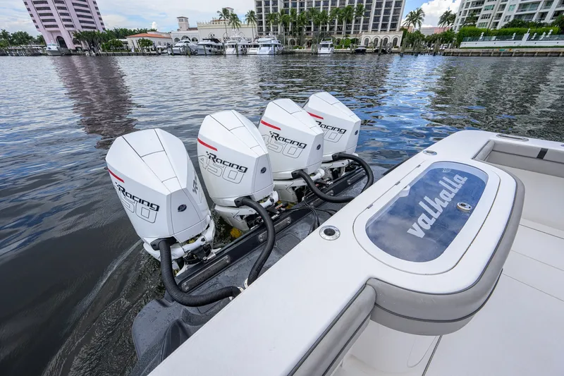 Slide: The Image of Valhalla V-41 boat with four powerful outboard engines on a calm waterfront. - 22