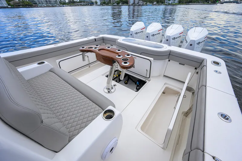 Slide: The Image of 2021 Valhalla V-41 boat interior with seating, storage, and outboard engines on water. - 29