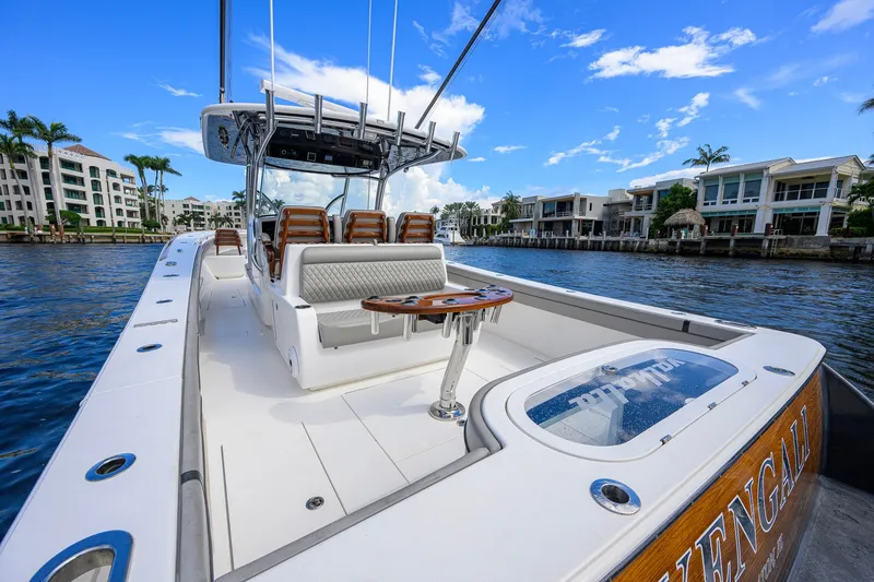 Slide: The Image of 2021 Valhalla V-41 boat cruising on a scenic waterfront with luxury homes. - 17