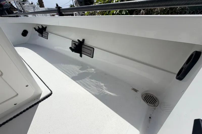 Slide: The Image of 2022 Beavertail Skiffs Mosquito 18' interior view, showcasing sleek white design and rod holders. - 24