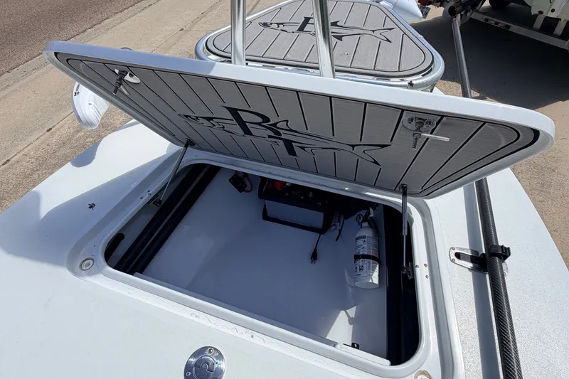 Slide: The Image of 2022 Beavertail Skiffs Mosquito 18' storage compartment with open hatch and fire extinguisher. - 26
