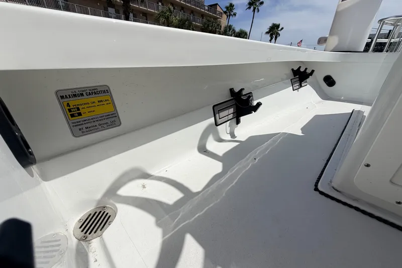Slide: The Image of 2022 Beavertail Skiffs Mosquito 18' interior with capacity label and rod holders. - 23