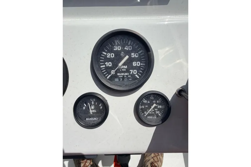 Slide: The Image of Dashboard gauges of a 2022 Beavertail Skiffs Mosquito 18' boat, featuring Suzuki instruments. - 11