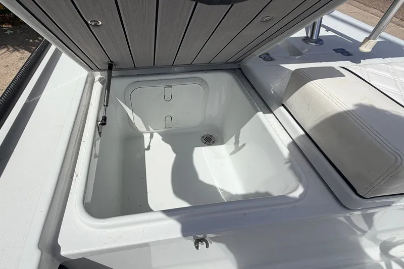 Slide: The Image of Open storage compartment on 2022 Beavertail Skiffs Mosquito 18' boat. - 18