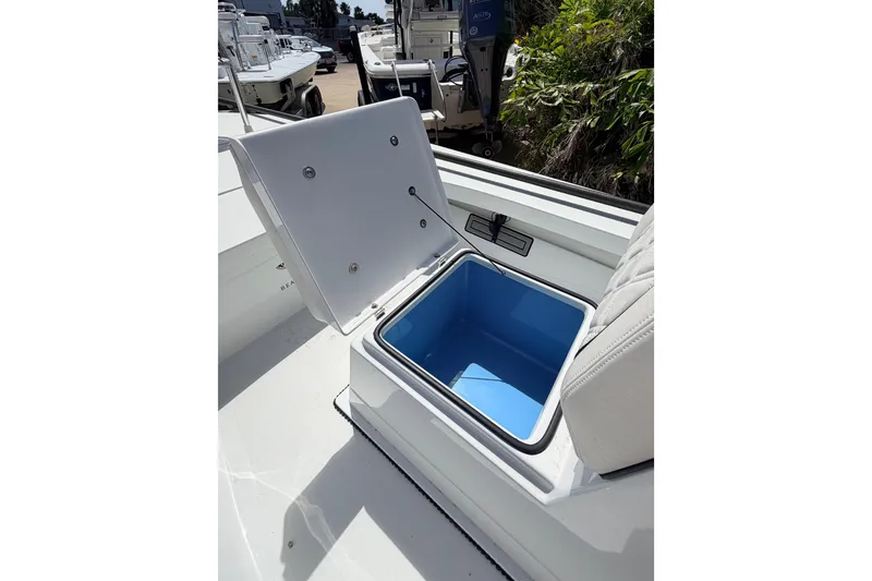 Slide: The Image of Open storage compartment on 2022 Beavertail Skiffs Mosquito 18' boat, featuring blue interior. - 8