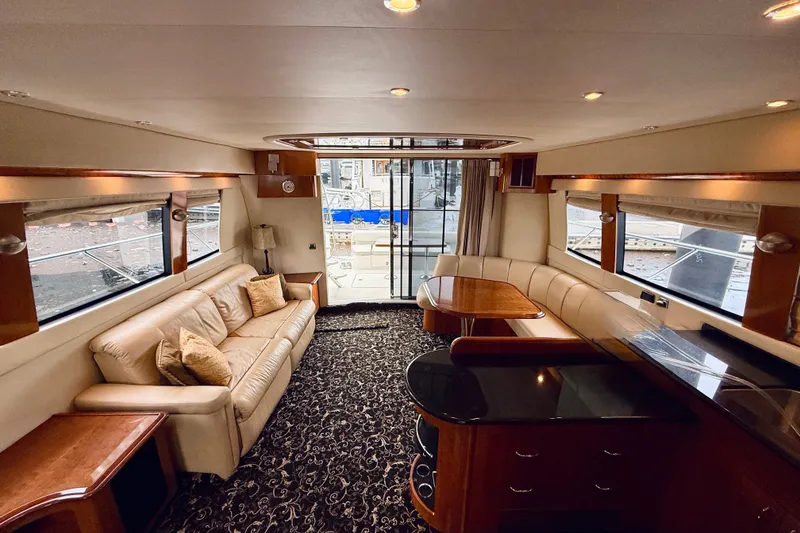 Slide: The Image of Luxurious interior of a 2005 Carver 56 Voyager yacht with elegant seating and dining area. - 27