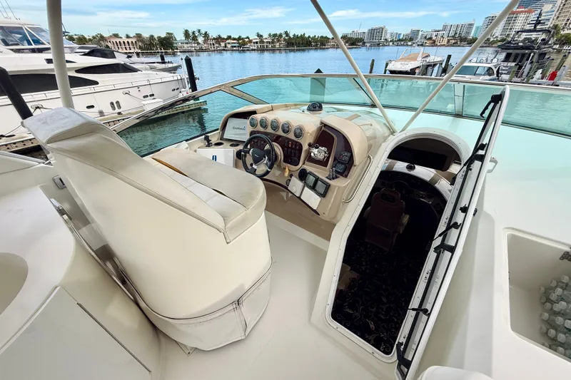 Slide: The Image of 2005 Carver 56 Voyager yacht helm with luxurious seating and waterfront view. - 65