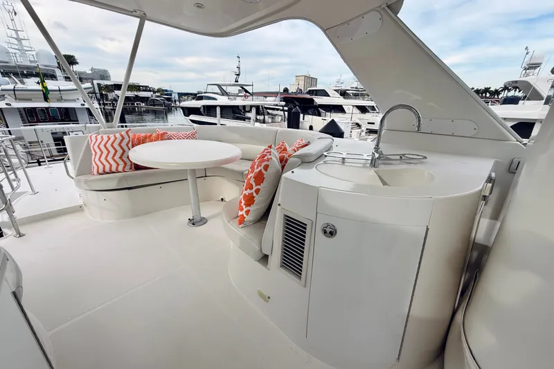 Slide: The Image of 2005 Carver 56 Voyager yacht deck with seating, table, and sink. - 64