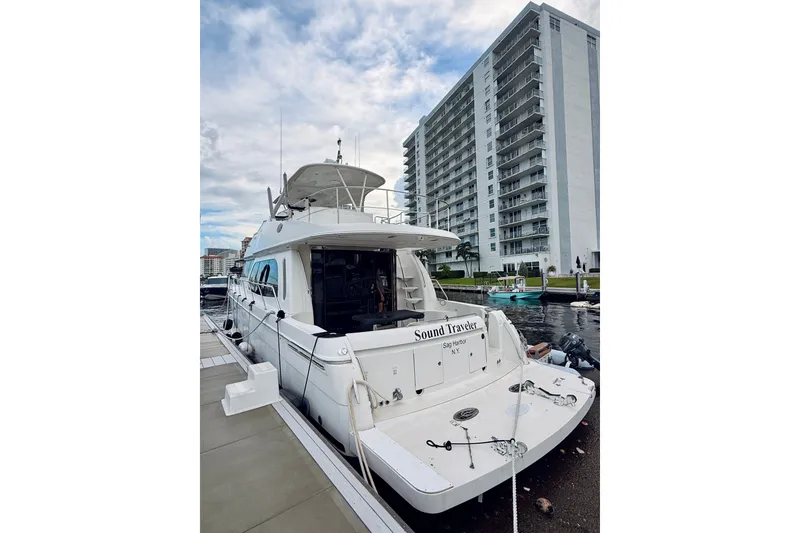 Slide: The Image of 2005 Carver 56 Voyager yacht docked near high-rise building. - 5