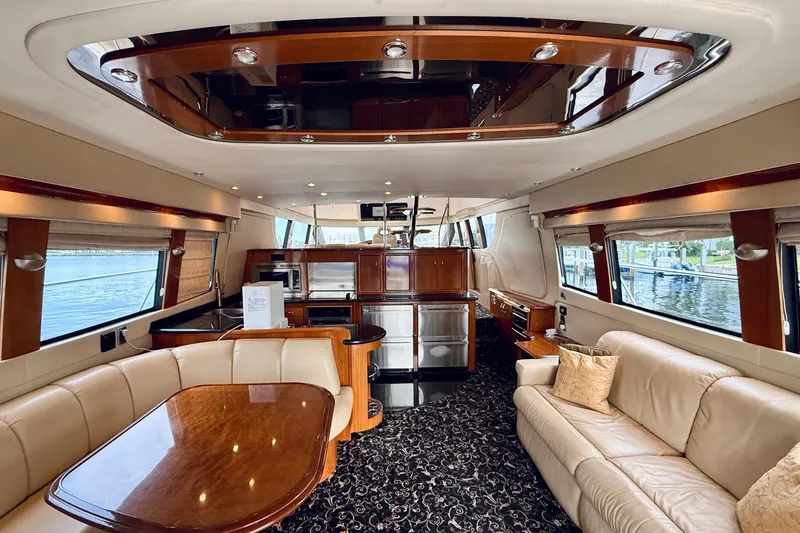 Slide: The Image of Luxurious interior of 2005 Carver 56 Voyager yacht with elegant wood finishes and plush seating. - 20