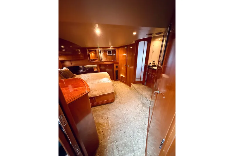 Slide: The Image of Luxurious interior of 2005 Carver 56 Voyager yacht with wood finishes and cozy bedroom. - 37