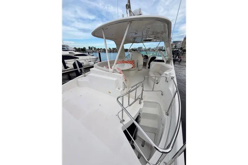 Slide: The Image of 2005 Carver 56 Voyager yacht with spacious deck and marina view. - 55