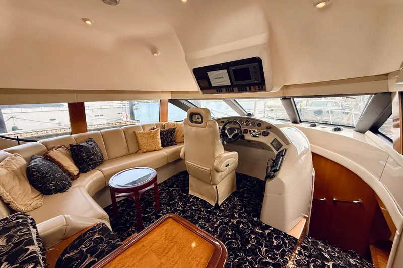 Slide: The Image of Luxurious interior of a 2005 Carver 56 Voyager yacht with plush seating and helm. - 28