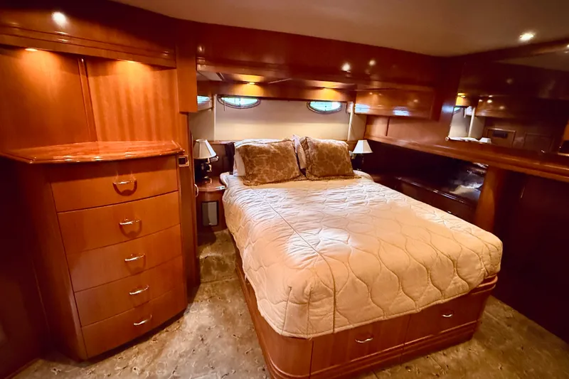 Slide: The Image of Luxurious bedroom interior of 2005 Carver 56 Voyager yacht with elegant wood finishes. - 44