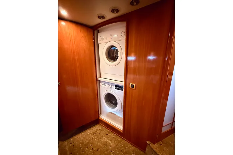 Slide: The Image of Laundry area with stacked washer and dryer in 2005 Carver 56 Voyager yacht. - 42