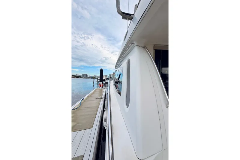 Slide: The Image of Side view of a 2005 Carver 56 Voyager yacht docked at a marina. - 13