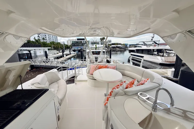 Slide: The Image of Luxurious 2005 Carver 56 Voyager yacht interior with plush seating and marina view. - 63