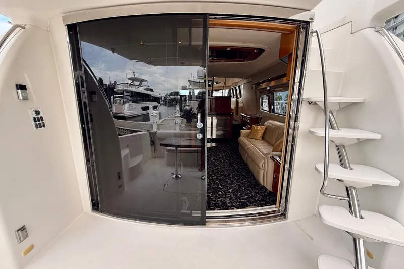 Slide: The Image of Interior view of a 2005 Carver 56 Voyager yacht with luxurious seating and modern design. - 14