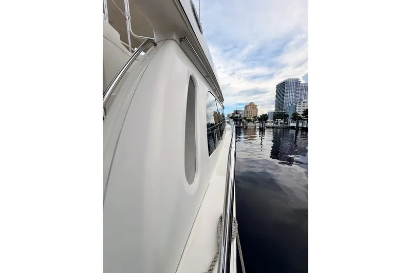 Slide: The Image of Side view of a 2005 Carver 56 Voyager yacht docked at a marina. - 12