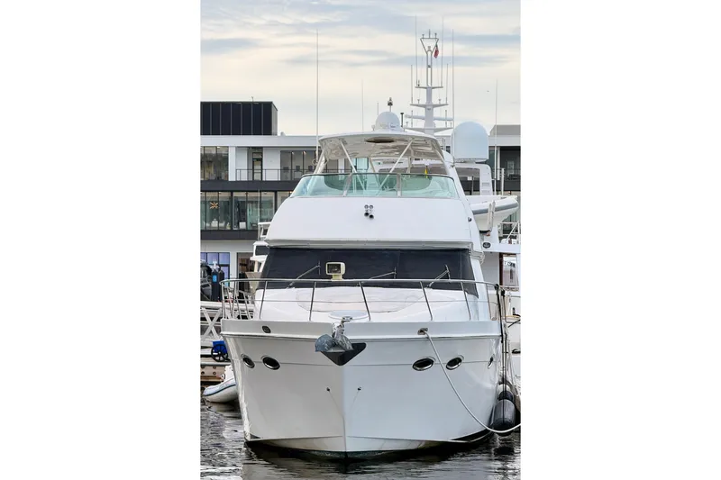 Slide: The Image of Front view of a 2005 Carver 56 Voyager yacht docked at a marina. - 3
