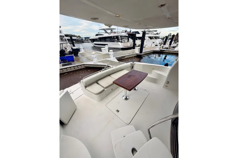 Slide: The Image of 2005 Carver 56 Voyager yacht deck with seating and table at marina. - 9