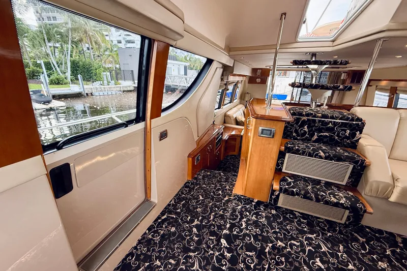 Slide: The Image of Interior of 2005 Carver 56 Voyager yacht with elegant staircase and plush seating. - 34