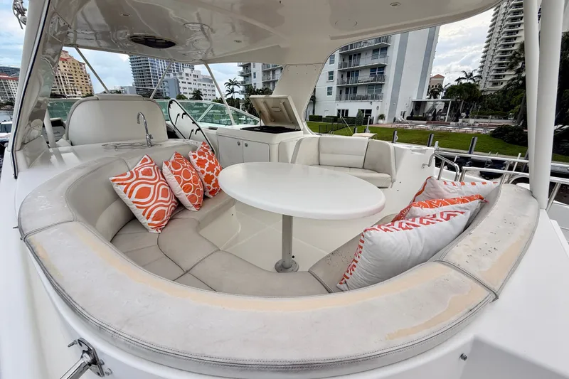 Slide: The Image of Luxurious 2005 Carver 56 Voyager yacht deck with cushioned seating and vibrant pillows. - 60