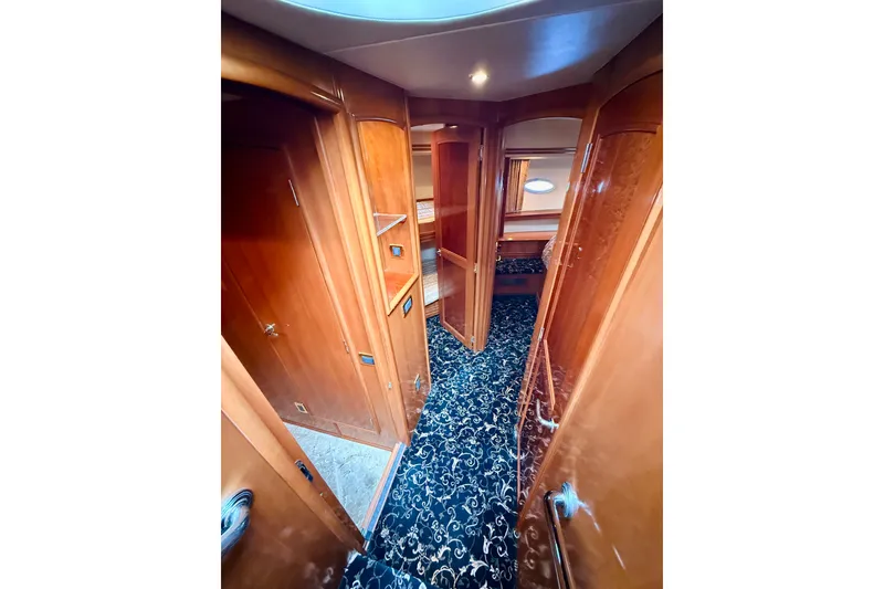 Slide: The Image of Luxurious interior of 2005 Carver 56 Voyager yacht with elegant wood finish and plush carpet. - 36