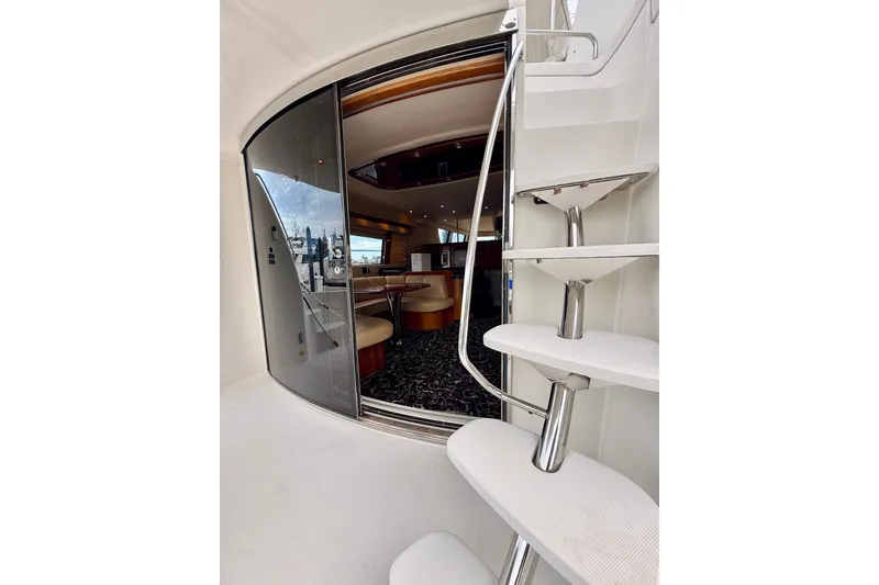 Slide: The Image of Interior view of 2005 Carver 56 Voyager yacht with modern design and spiral staircase. - 15