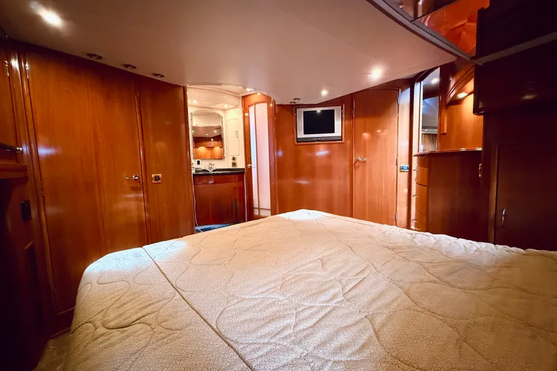Slide: The Image of Luxurious interior of 2005 Carver 56 Voyager yacht with wood paneling and cozy bedding. - 40