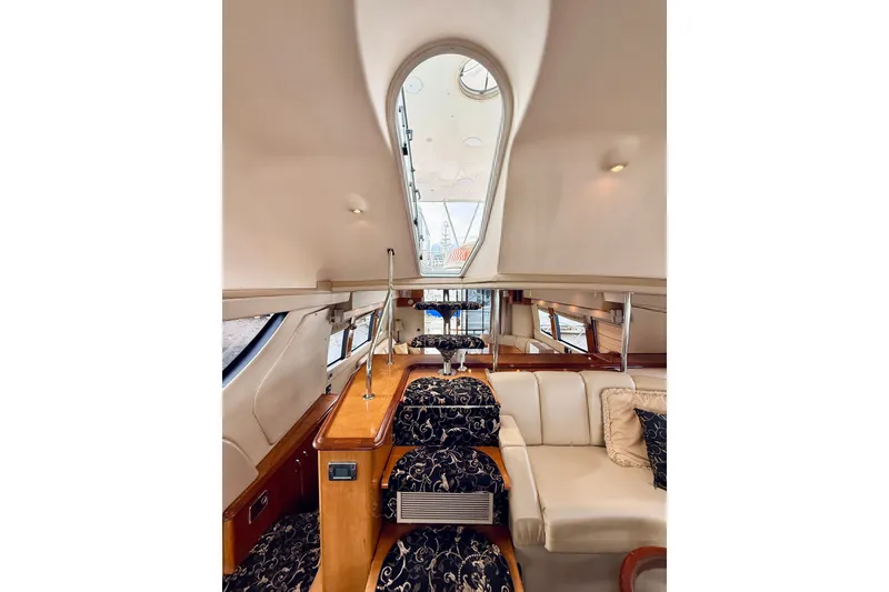 Slide: The Image of Luxurious interior of 2005 Carver 56 Voyager yacht with elegant seating and wood finishes. - 33