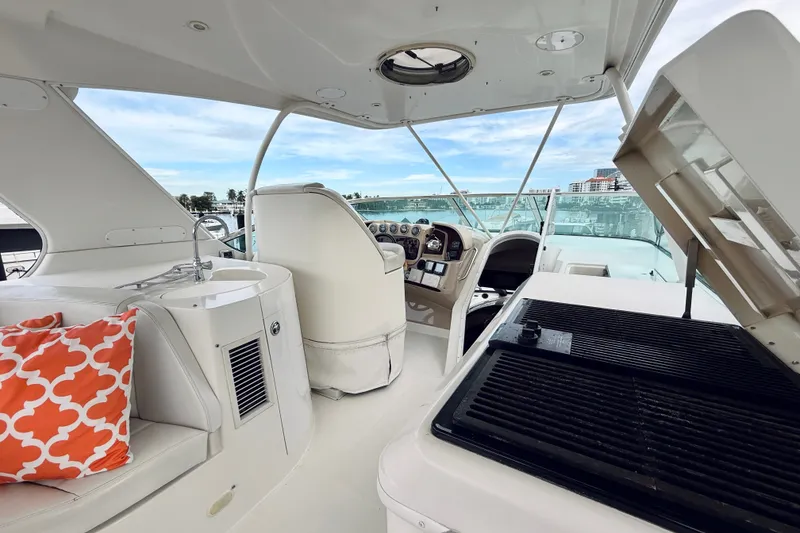 Slide: The Image of 2005 Carver 56 Voyager yacht interior with helm, grill, and seating area. - 62