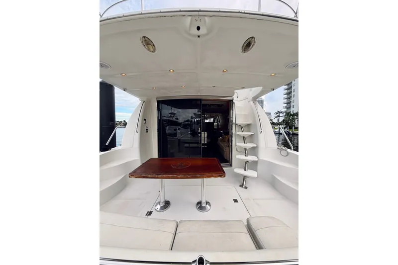 Slide: The Image of 2005 Carver 56 Voyager yacht deck with table and seating area. - 8