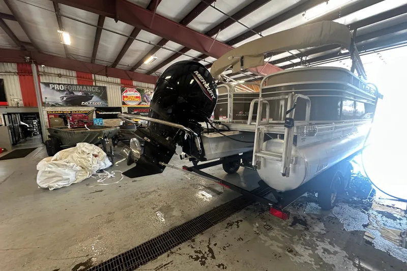 Slide: The Image of 2020 Sun Tracker Party Barge 22 DLX pontoon boat in a workshop setting. - 15