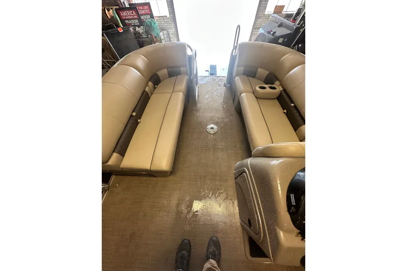 Slide: The Image of 2020 Sun Tracker Party Barge 22 DLX interior with beige seating and cup holders. - 14