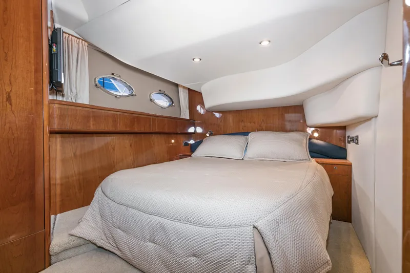 Slide: The Image of 2007 Viking Sport Cruiser bedroom with cozy bed and wooden interior design. - 24