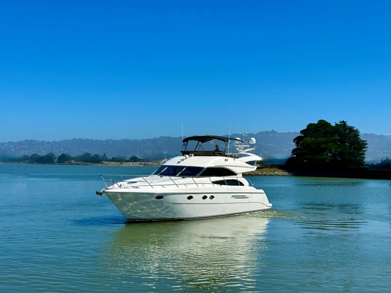 Slide: The Image of 2007 Viking Sport Cruiser yacht on calm water under clear blue sky. - 51