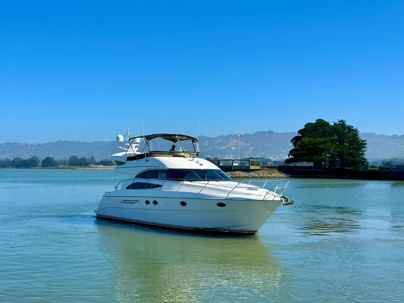 Slide: The Image of 2007 Viking Sport Cruiser yacht on calm water with scenic background. - 50