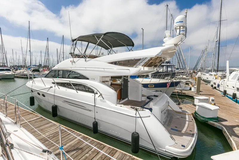 Slide: The Image of 2007 Viking Sport Cruiser yacht docked at marina, featuring sleek design and spacious deck. - 38
