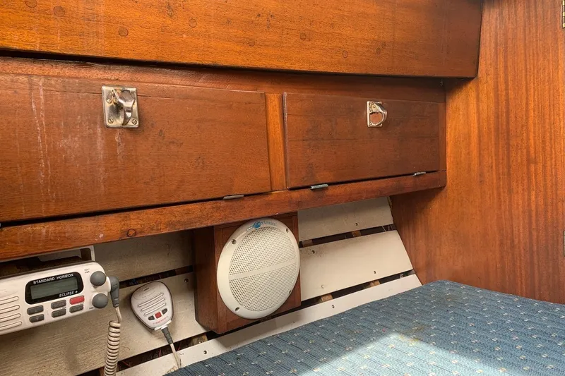 Slide: The Image of Interior of 1975 Halberg Rassey P-28 sailboat with wooden cabinets and radio equipment. - 28